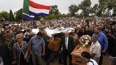 Supporters of the white supremacist leader Eugene Terreblanche, look at his coffin outside the church in Ventersdorp, South Africa, Friday, April 9, 2010.