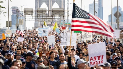Hundreds of people march across the Brooklyn Bridge during a protest against the Covid-19 vaccination mandates for municipal employees in New York. EPA