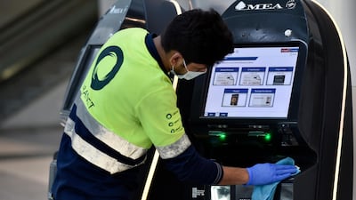A worker disinfects self check-in counters of the Middle East Airlines at the departure hall of Rafik Hariri international airport in Beirut, Lebanon. EPA