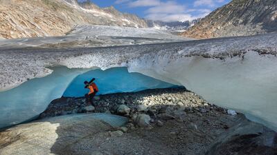Glaciologist Matthias Huss enters an ice cave at the tongue of the Rhone glacier, which has been affected by climate change, in Obergoms, Switzerland. Reuters