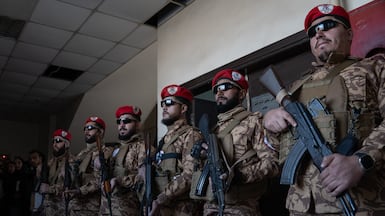 Syrian security personnel stand guard outside the courtroom in Aleppo. Anagha Nair for The National