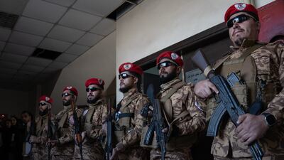 Syrian security personnel stand guard outside the courtroom in Aleppo. Anagha Nair for The National