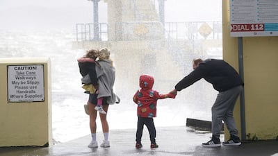 People look at the waves at Blackrock Diving Board. PA