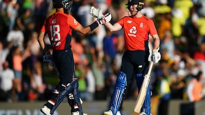 Eoin Morgan, right, and Moeen Ali celebrate England's victory during the third T20 against South Africa in Centurion on Sunday. Getty Images