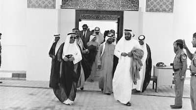 Sheikh Khalifa bin Zayed Al Nayhan, right, leaves Qasr al Hosn after the opening session of the Ruling National Council in 1977. Al Ittihad