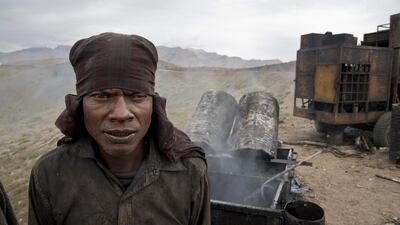 A worker stands next to a stove of liquid asphalt by a road under construction leading to Demul in Spiti Valley. Thomas Cytrynowicz / AP Photo
