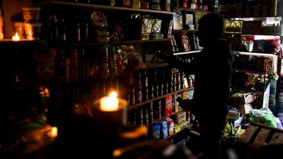 A vendor waits for customers during a national blackout, in Buenos Aires, Argentina. Reuters