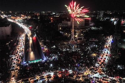 Fireworks erupt above people celebrating the fall of Bashar Al Assad at Umayyad Square in central Damascus. AFP