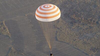 Soyuz TMA-09M capsule carrying the International Space Station (ISS) crew members, Fyodor Yurchikhin of Russia, Karen Nyberg of the United States and Luca Parmitano of Italy, descends with a parachute before landing in a remote area near the town of Zhezkazgan in central Kazakhstan Monday, Nov. 11, 2013. Shamil Zhumatov / AP Photo