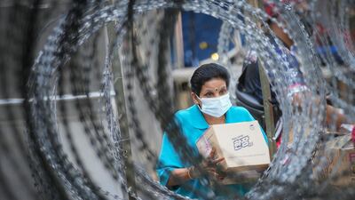 A resident outside the Pangsapuri Permai housing estate, which is under an enhanced movement control order because of a severe increase in the number of Covid-19 cases recorded over the past 10 days in Cheras, outside Kuala Lumpur, Malaysia. AP Photo