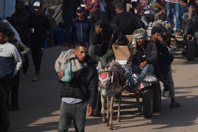 Palestinians carry boxes from the Gaza Humanitarian Foundation, a US aid organisation backed by Israel as a way of bypassing Hamas. AP