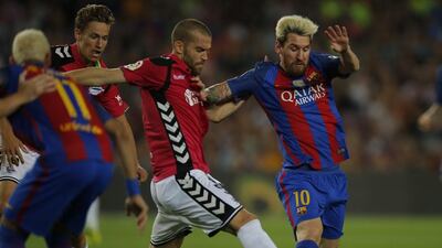 Barcelona's Lionel Messi, right, duels for the ball against Alaves's Victor Laguardia. Manu Fernandez / AP Photo