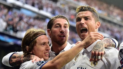 Cristiano Ronaldo, right, scored all three goals in Real Madrid's 3-0 win over Atletico Madrid in the Uefa Champions :eague semi-final first leg on Tuesday night. Gerard Julien / AFP