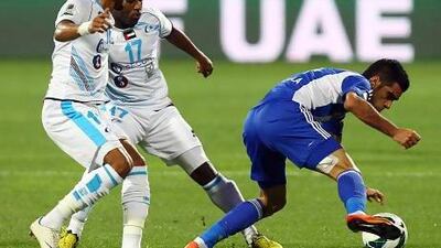From left, Fawaz Musabi and Nawaf Musabi of Baniyas try to stop Humaid Ahmed. Satish Kumar / The National