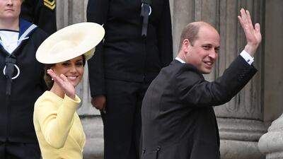 The Duchess and Duke of Cambridge wave to the crowd as they arrive at the service of thanksgiving. Getty Images