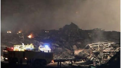 Smoke rises from the crash scene where a cargo plane owned by UPS came down at a military base in Dubai, killing the two pilots.