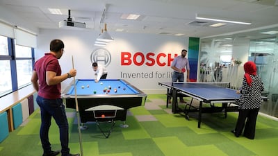 Employees playing snooker and table tennis in the recreational room at the Bosch Middle East office in Dubai. Pawan Singh / The National