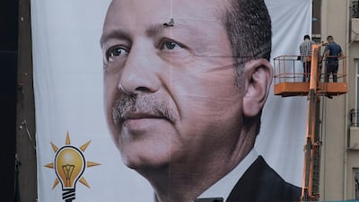 Workers hang up a wall poster of Turkish president Recep Tayyip Erdogan at Taksim Square in Istanbul, Turkey. Sedat Suna / EPA