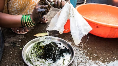 To ease the process of squeezing, the leaves are wrapped in a cotton cloth.