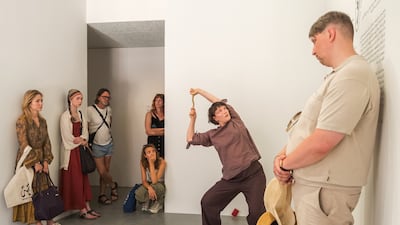 A performer in Taus Makhacheva’s And What Did You Say? (2026) uses movement and objects to explore how gossip enters the body, changes shape and passes between people. Photo: National Pavilion UAE