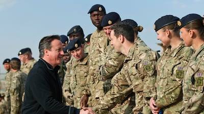 Then-prime minister David Cameron talks to British soldiers during a visit to Camp Bastion in 2013