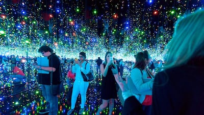 Visitors at Yayoi Kusama’s infinity room, where twinkling lights are reflected off the water and mirrored walls. Courtesy Guggenheim Abu Dhabi