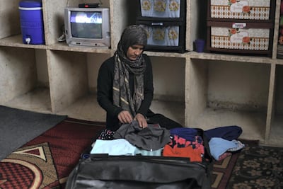 Haleema packs for her family's attempt to cross into Turkey at their home in Maaret Al Numan, in Syria's Idlib province. Photo by Abdul Azez Ketaz