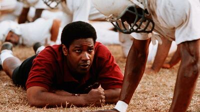 Denzel Washington portrays real-life football coach, Herman Boone, who battled racism and injustice to put together a team of black and white players in a newly desegregated Virginia school in 'Remember The Titans'. Shutterstock