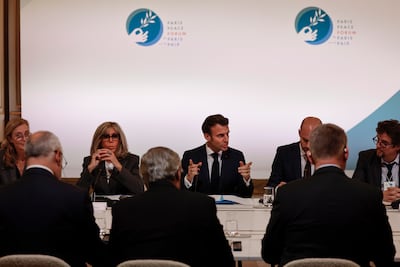 President Emmanuel Macron and his wife Brigitte attend a round-table discusion at the Paris Peace Forum. EPA