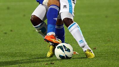 Humaid Ahmed of Al Nasr and Nawaf Mubarak Musabh of Baniyas clash for the ball. Satish Kumar / The National