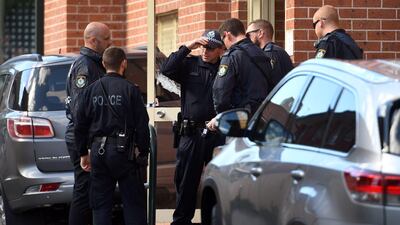 Police emerge from the block of flats in the Sydney suburb of Lakemba after a search. William West.