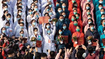 Medical staff celebrate after all patients were discharged at Wuchang Fangcang Hospital, a temporary hospital set up at Hongshan Gymnasium to treat people infected with the coronavirus and COVID-19 disease, in Wuhan, Hubei Province, China. AP