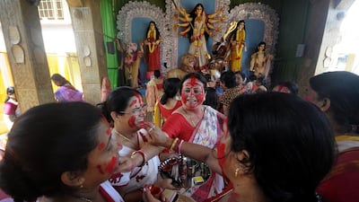 Indian women apply vermillion powder to each other as a ritual during Dashami, the last day of the Hindu festival of Durga Puja in Agartala, the capital of northeastern state of Tripura. Arindam Dey / AFP Photo