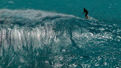 A surfer cruises a wave at the Wadi Adventure park in Al Ain. Christopher Pike / The National
