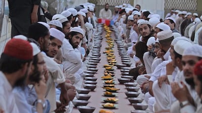 Pakistani Muslims pray before eating in the evening on the first day of Ramadan in Peshawar, Pakistan on June 29, 2014. Bilawal Arbab/EPA