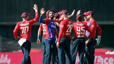 England's Saqib Mahmood celebrates with teammates after taking the wicket of Pakistan's Babar Azam during the second T20 in Leeds on Sunday