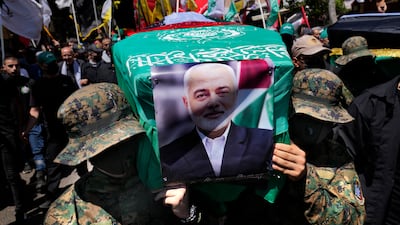 Hamas fighters carry a mock coffin of the group's leader, Ismail Haniyeh, during a symbolic funeral procession in Beirut, Lebanon, on Friday. AP