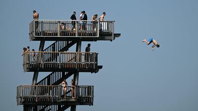 A boy jumping from a diving tower on the shore of lake Ammersee in southern Germany as the temperature reached around 30°C. AFP