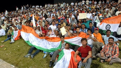 Indian supporters cheer for their team during the second DLF Cup game between India and Pakistan at Zayed Cricket Stadium in Abu Dhabi. AFP