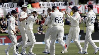 England's Joe Denly, third left, is congratulated by teammates after taking a catch to dismiss New Zealand batsman Jeet Raval. AP