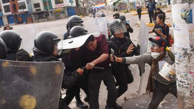 Protesters clash with members of the Peruvian riot police during a demonstration in the city of Cusco, Peru. AFP