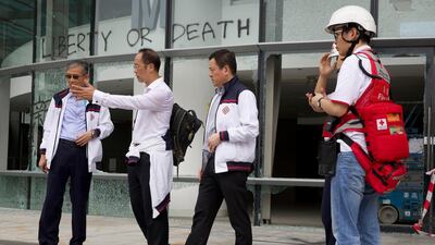 Prof. Alex Wai, second from left, a vice president with the Hong Kong Polytechnic University prepares to lead a team to look for holed up protesters on the university campus in Hong Kong. Hong Kong's embattled leader Carrie Lam refused to offer any concessions to anti-government protesters despite a local election trouncing, saying Tuesday that she will instead accelerate dialogue and identify ways to address societal grievances. AP Photo