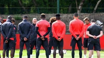 Manchester United players and staff hold a minute's silence in memory of the victims of the Manchester Concert attack during a Manchester United training session ahead of the Europa League final against Ajax at the Aon Training Complex on May 23, 2017 in Manchester, England. Dave Thompson / EPA