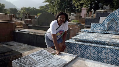 Rosangela dos Santos, the daughter of former football player Garrincha, looks over the tomb in the municipal cemetery of Raiz da Serra, Rio de Janeiro, Brazil. Marcelo Sayao / EPA