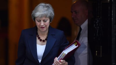 Britain's Prime Minister Theresa May leaves Downing Street yesterday to attend the weekly Prime Minister's Questions at the Houses of Parliament. / AFP / Ben STANSALL