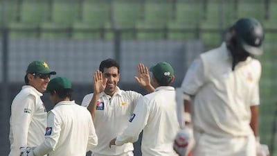 Pakistan bowler Umar Gul, centre, celebrates he dismissal of Shahriar Nafees, right. Munir uz Zaman / AFP