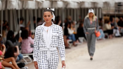 As part of the Chanel cruise 2022/23 collection, the famous house tweed patterning has been rethought to echo the chequered flag of the Grand Prix. Photo: EPA
