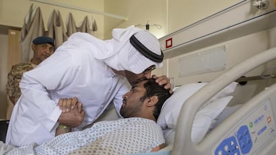 Sheikh Mohammed bin Zayed greets an injured serviceman at Mafraq Hospital.