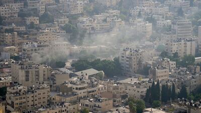 Smoke rises above buildings during the Israeli army operation in Nablus. AP Photo