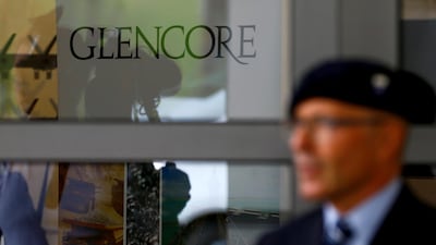 FILE PHOTO: A security guard stands in front of the Glencore logo. The firm is under investigation in the US. Arnd Wiegmann/Reuters